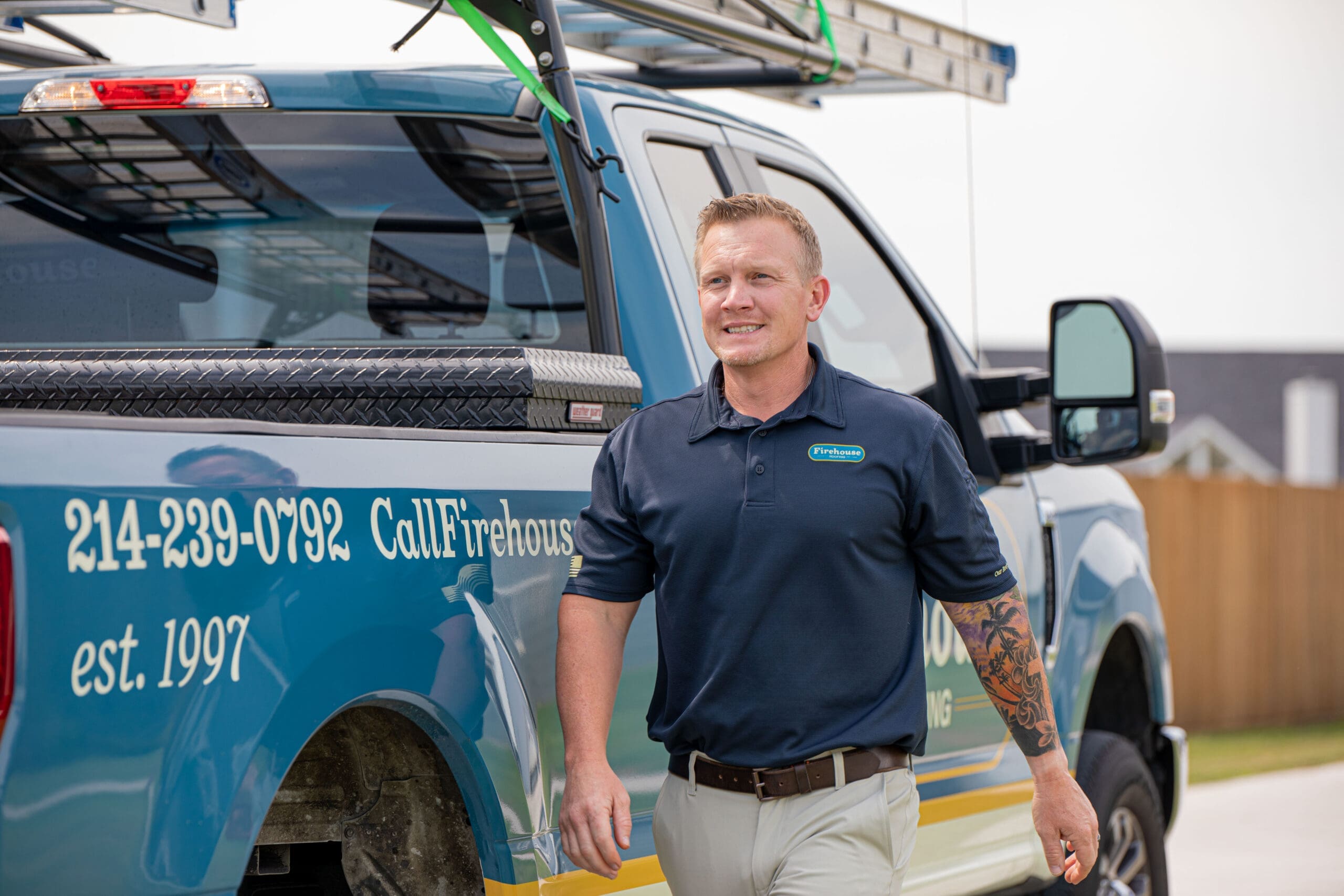 A Firehouse Roofing technician at the service truck in the Dallas-Fort Worth area.